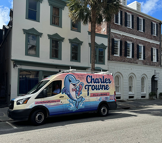 Photo of a Charles Towne Plumbing van parked in front of commercial buildings